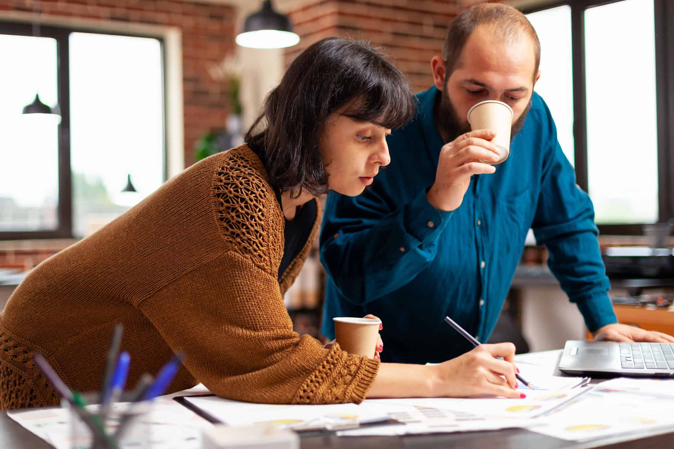 Coworkers analyzing website metrics to improve strategy.